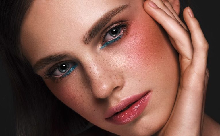 Beautiful girl with creative colorful makeup. Beauty face. Photos shot in studio